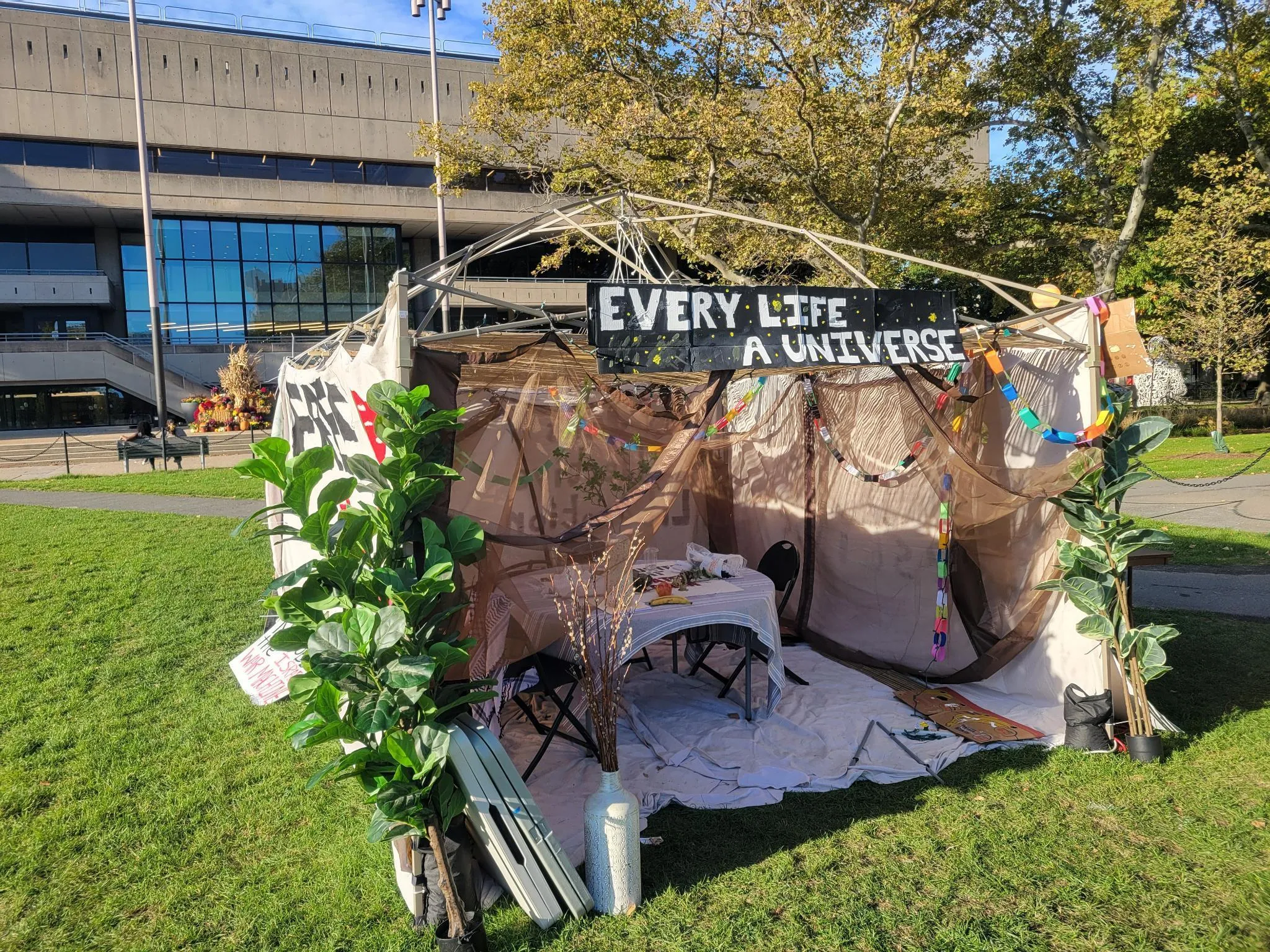 Entrance to sukkah with “every life a universe” sign at the top